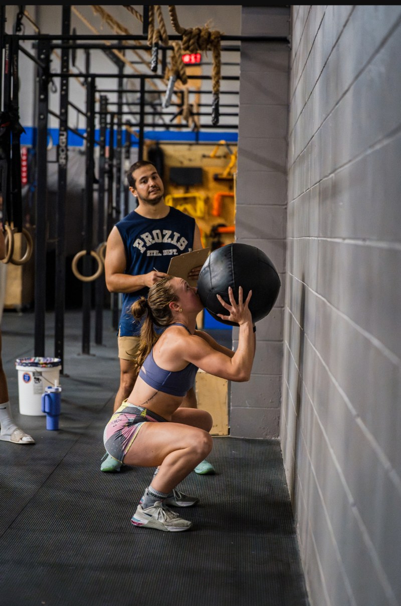 Jenna catching a wall ball at the bottom of a squat